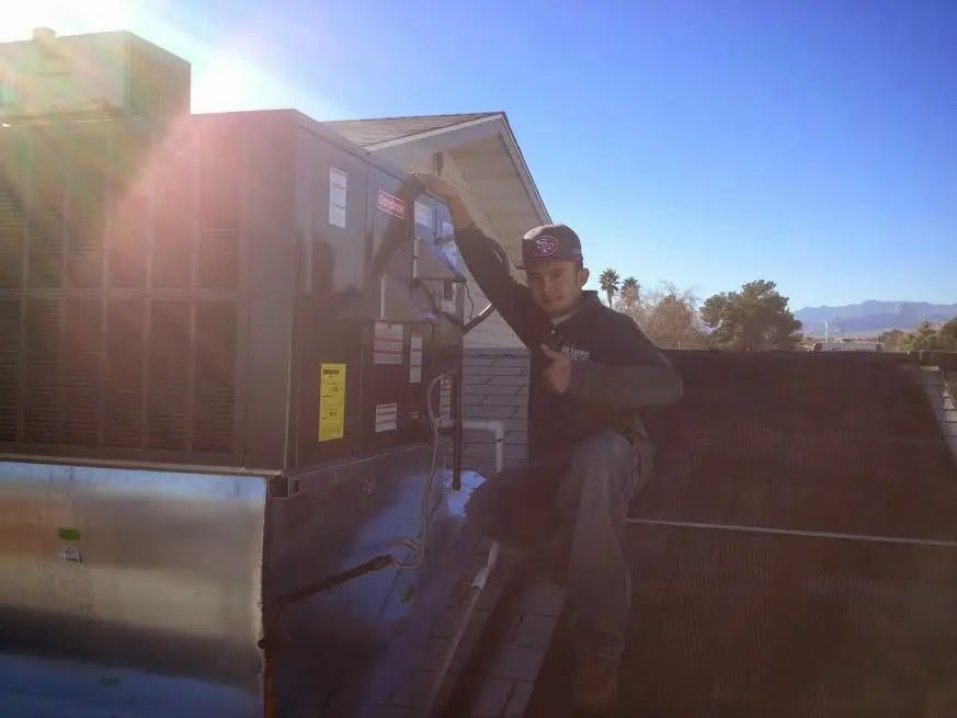 HVAC technician performing Boiler Repair on a rooftop unit in Millbrae